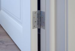 How do I fix a squeaky door?
